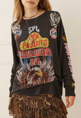 a-woman-wearing-a-black-long-sleeve-graphic-sweatshirt-with-a-large-pajarito-margarita-bar-design-on-the-front-featuring-an-eagle-route-66-style-shield-and-other-western-themed-graphics